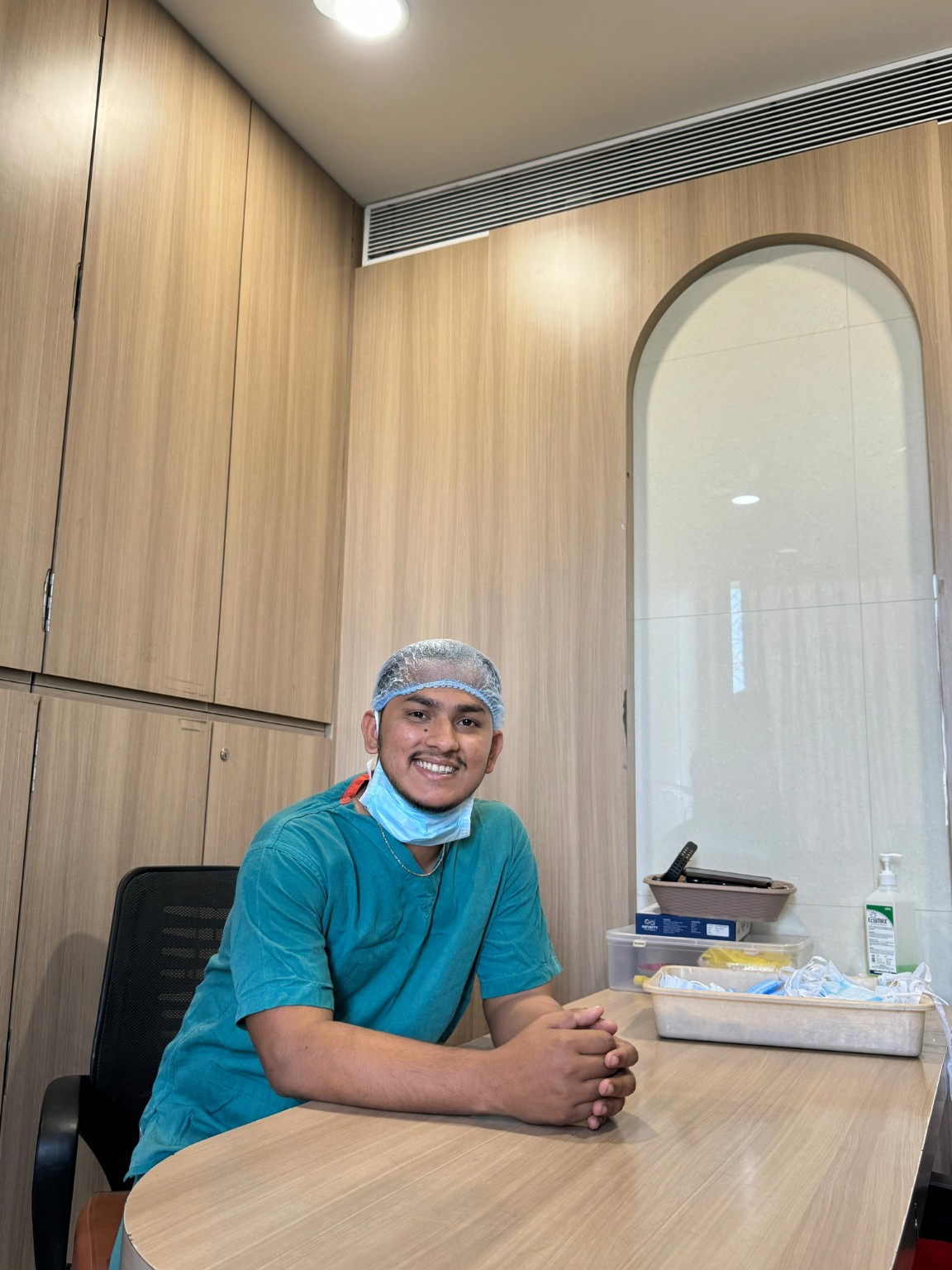Dr. Shivam Chaudhary, PT seated in clinical scrubs